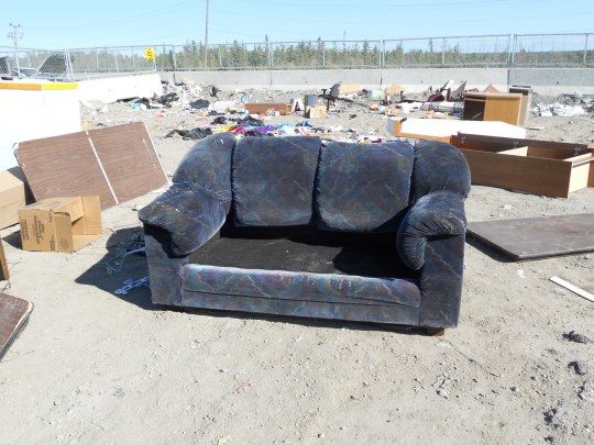 Couch, sans cushions, at the dump
