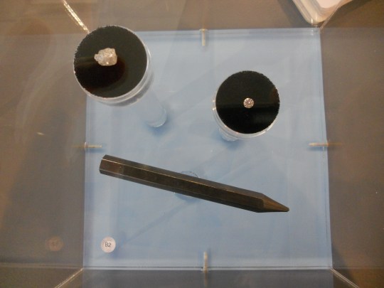 Rough diamond, polished diamond and graphite pencil